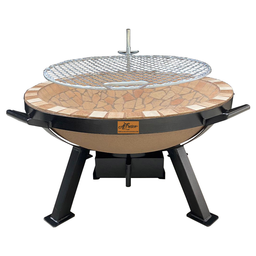 Alfresco Fire Pit by The Gas Boys, front view showing circular metal fire pit with a grilling surface and surrounding stone base.