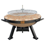 Alfresco Fire Pit by The Gas Boys, front view showing circular metal fire pit with a grilling surface and surrounding stone base.