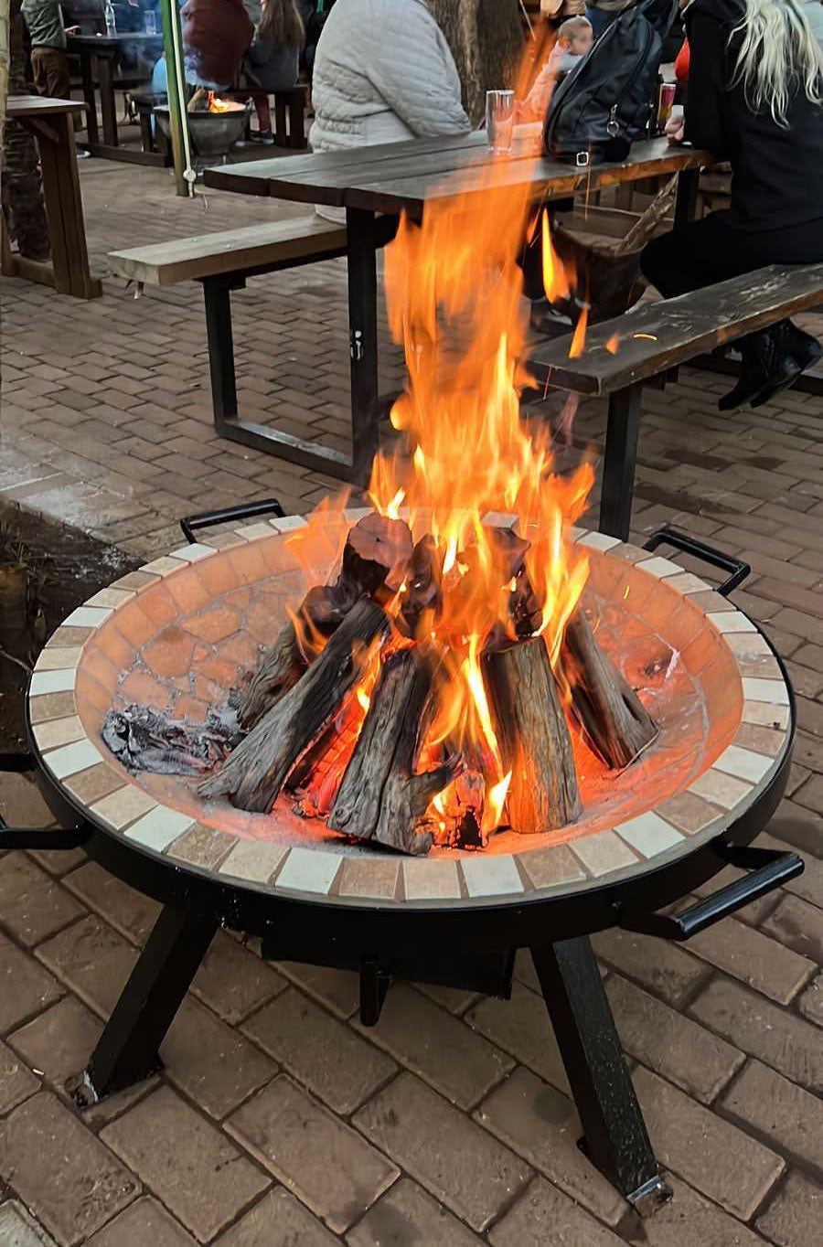 AlFresco Fire Pits by The Gas Boys featuring a modern outdoor fire pit with a circular design and stone base.