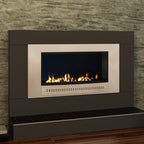 Close-up of a Chad-O-Chef Classic Fireplace with stainless steel frame and midnight mirror back in a stylish living room setting.