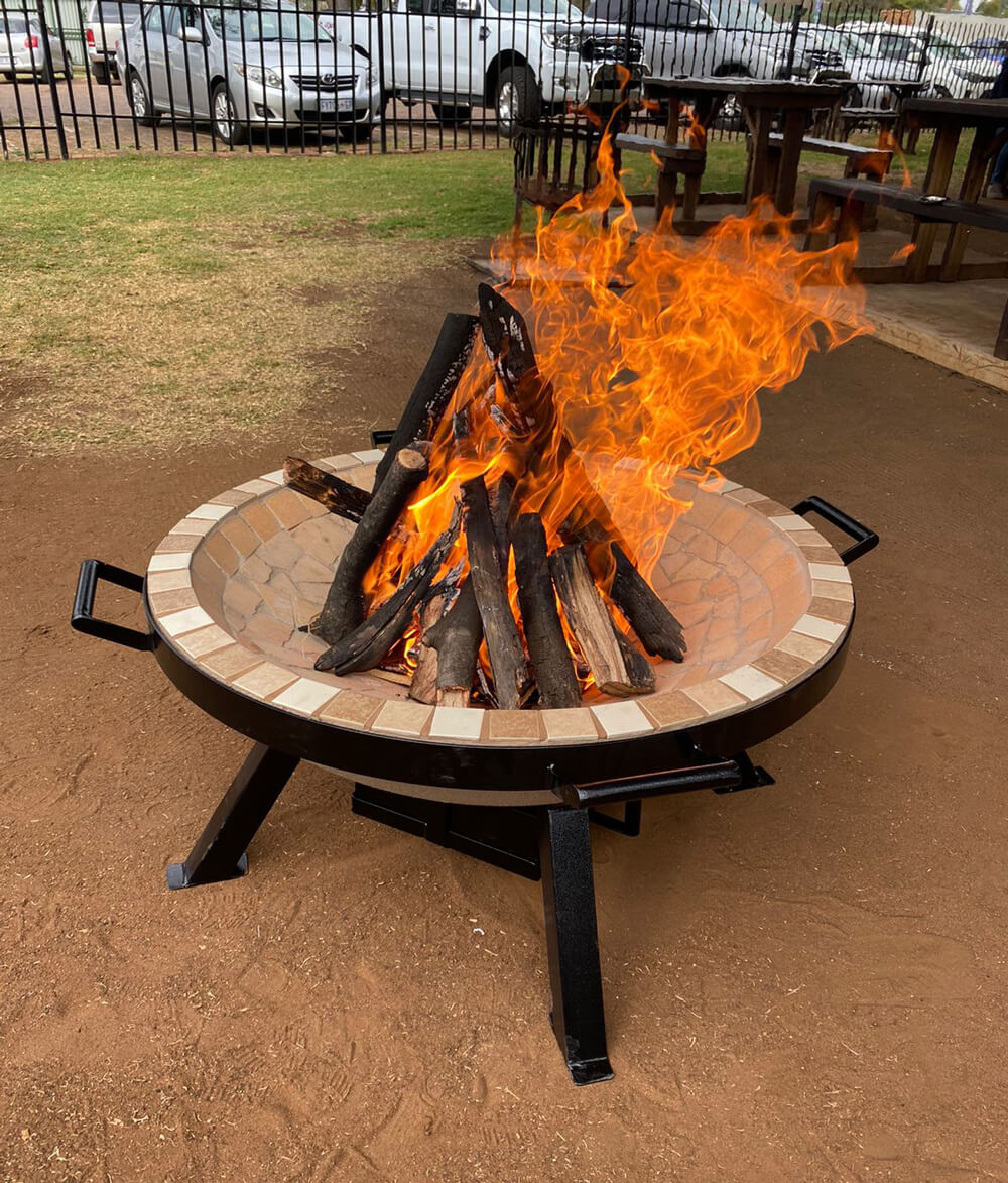 AlFresco Fire Pits by The Gas Boys featuring a modern fire pit with a sturdy metal bowl and decorative stone surround.