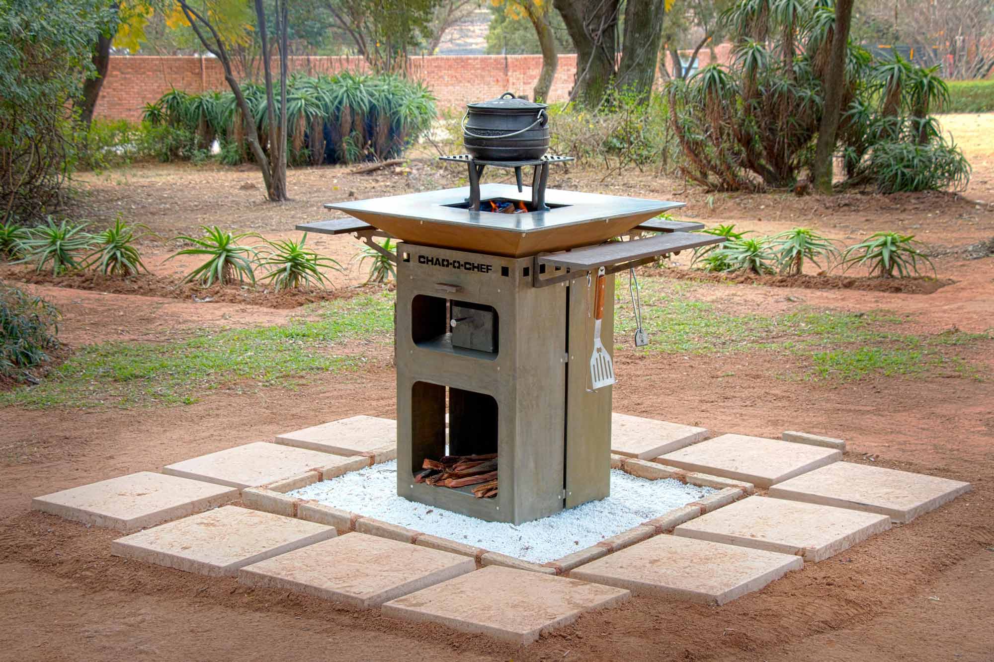 Chad-O-Chef Boma woodfire braai with open cooking surface and durable metal construction for outdoor grilling and barbecuing.