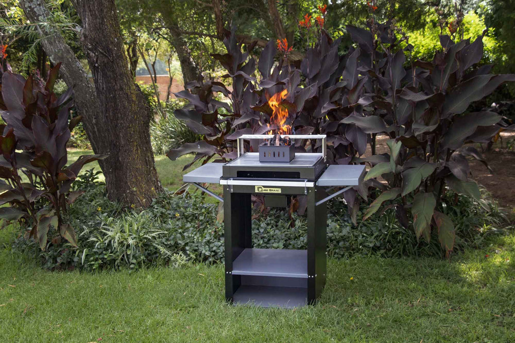 Chad-O-Chef Qube Braai outdoor cooking grill with stainless steel design and spacious cooking surface in a backyard setting