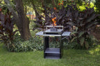 Chad-O-Chef Qube Braai outdoor cooking grill with stainless steel design and spacious cooking surface in a backyard setting