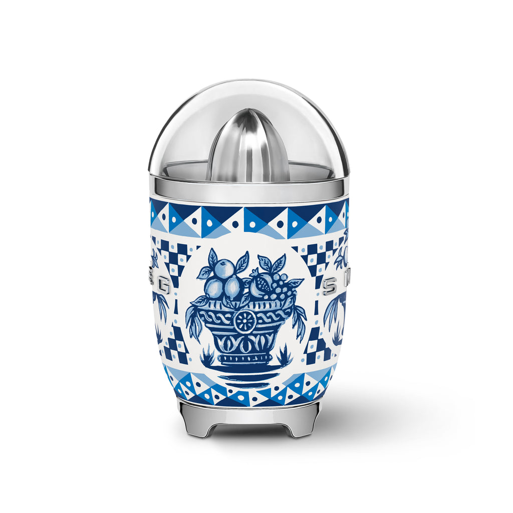 Smeg Dolce & Gabbana Blu Mediterraneo citrus juicer with blue and silver finish, featuring a compact design and textured surface.