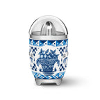 Smeg Dolce & Gabbana Blu Mediterraneo citrus juicer with blue and silver finish, featuring a compact design and textured surface.
