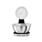 Smeg digital and analog kitchen scale with sleek white design and digital display, perfect for precise food measurements.