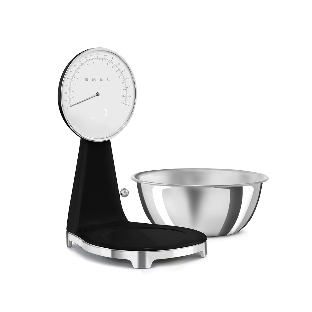 Smeg digital and analog kitchen scale with a sleek white design, featuring a digital display and analog dial for precise measurements.