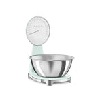 Smeg digital and analog kitchen scale with sleek white design, featuring a digital display and analog dial for precise measurements.